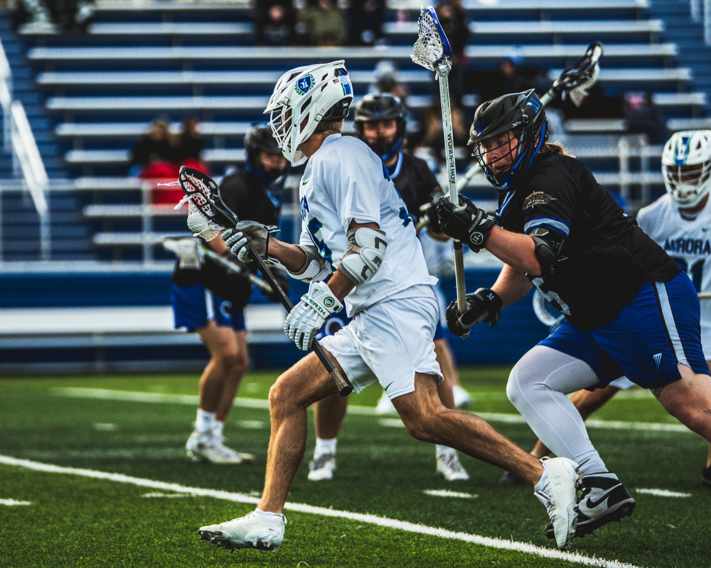 Lacrosse midfielder dodging a defender
