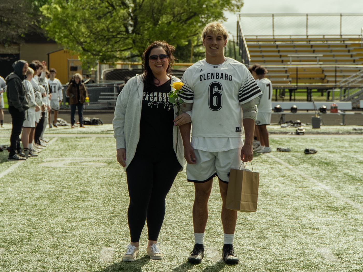 Senior athlete walking out with family on senior day